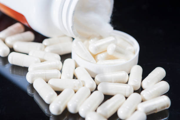 istock Closeup of Plenty White Pulls Placed Bulk In Front of Original Bottle 923066052