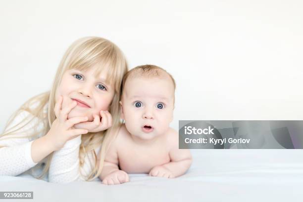 Portrait Of Brother And Sister Two Cute Children Lying On Bed Openeyed Surprised Or Astonished Expression Brother And Sister Best Friends Happy Family And Childhood Concept Stock Photo - Download Image Now