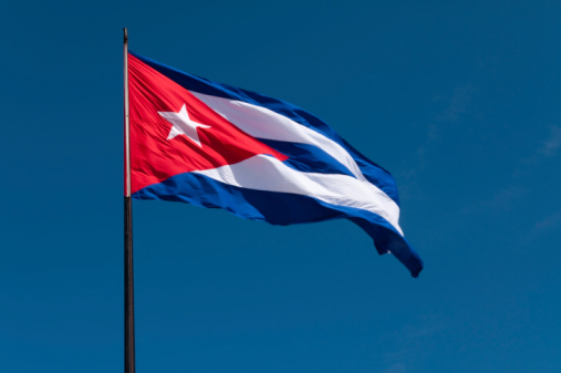 Cuban flag on a sunny windy day with a dark blue background shot from below.  See my other images from this region in the Lightbox