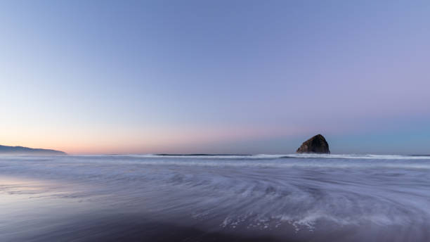 istock Pacific Ocean Calm Sunrise at Haystack Rock in Pacific City, Oregon 923072772
