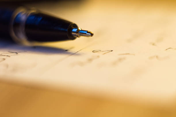 istock ball point pen and a sheet of paper 923073028