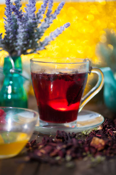 istock Hibiscus tea in a glass cup on a wooden background 923075646