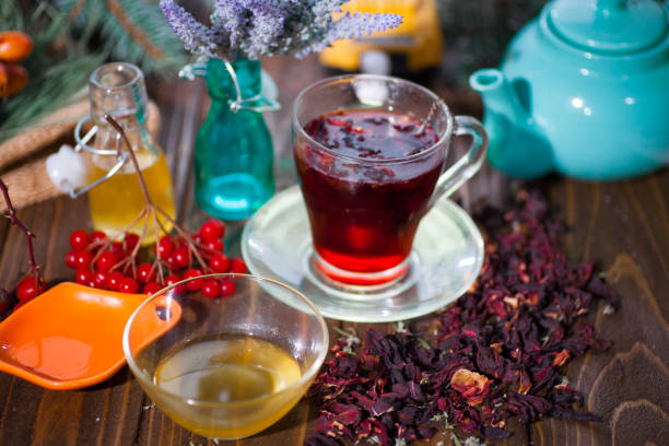 istock Hibiscus tea in a glass cup on a wooden background 923075920