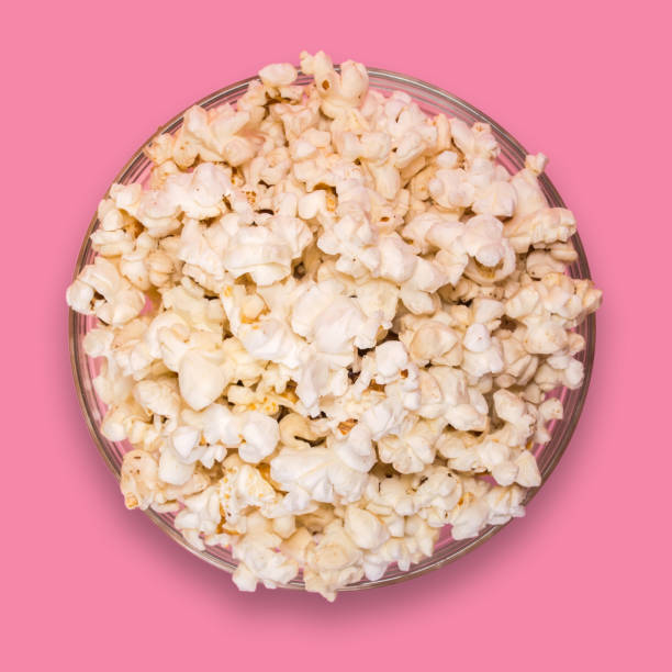 istock Popcorn in a transparent plate on a pink background. 923078632