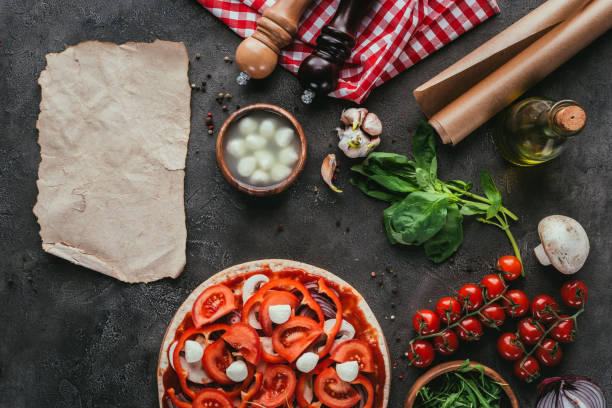 istock top view of uncooked pizza with ingredients and blank paper on concrete table 923078644