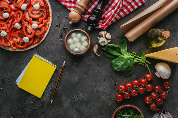 istock top view of uncooked pizza with notebook for recipe on concrete table 923078754
