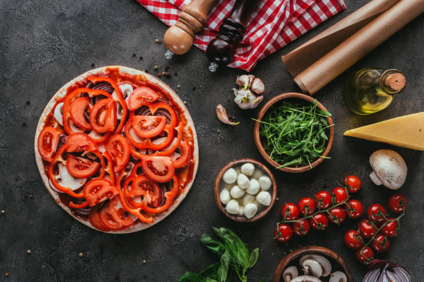 istock top view of uncooked pizza with various ingredients on concrete table 923078986