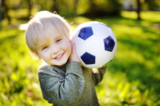 istock Little boy having fun playing a soccer game on sunny summer day 923079510