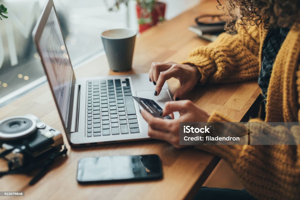 Online shopping Woman in cafe shopping online with laptop Online Shopping Stock Photo