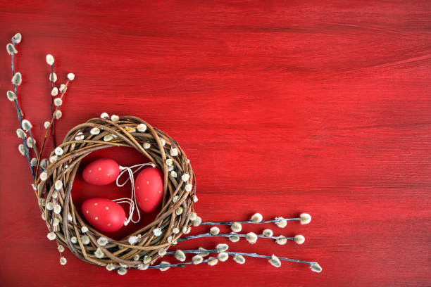 red easter background. easter willow wreath with red  easter eggs on red background. top view, copy space. greeting card - easter eggs red imagens e fotografias de stock