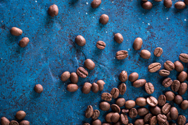 istock roasted coffee beans on blue table, can be used as a background 923086056