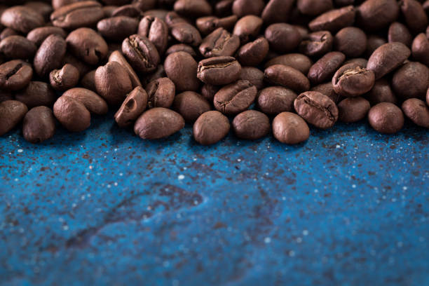 istock roasted coffee beans on blue table, can be used as a background 923086672