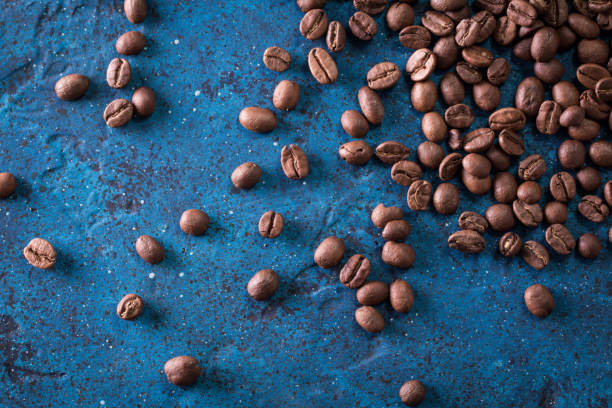 istock roasted coffee beans on blue table, can be used as a background 923089238
