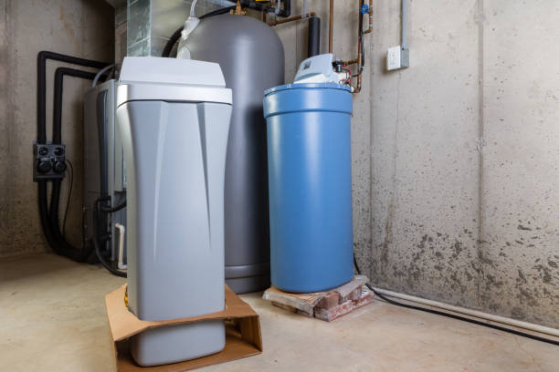 istock Old and new water softener tanks in a utility room 923089282