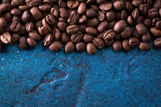 istock roasted coffee beans on blue table, can be used as a background 923089504