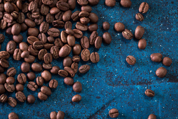 istock roasted coffee beans on blue table, can be used as a background 923089750