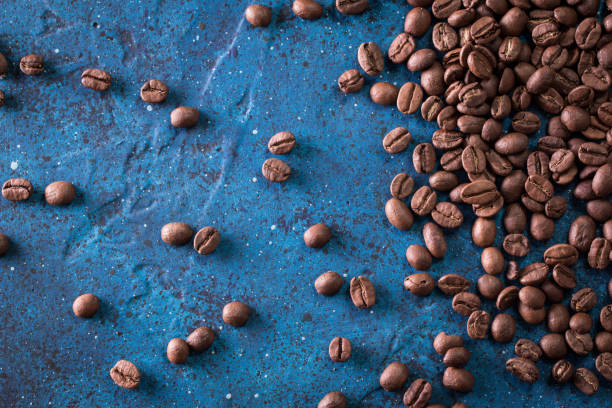 istock roasted coffee beans on blue table, can be used as a background 923092068
