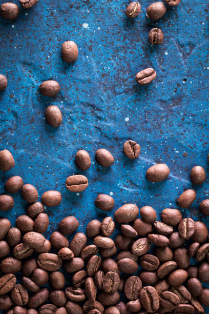 istock roasted coffee beans on blue table, can be used as a background 923092468