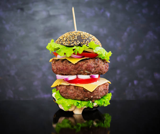 istock Handmade burger on dark background. Delicious black burger 923099526