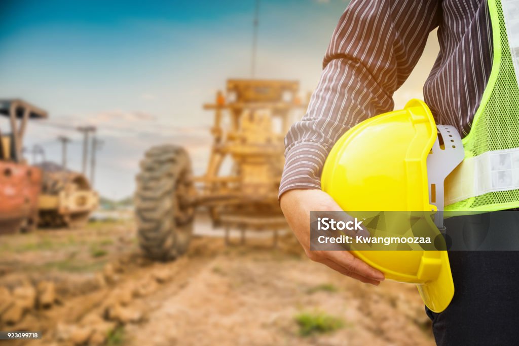 Asian business man construction engineer worker with yellow protective helmet at construction site Mining - Natural Resources Stock Photo