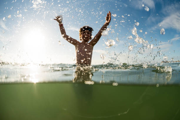 istock Child having joy and excitement in the ocean 923099884