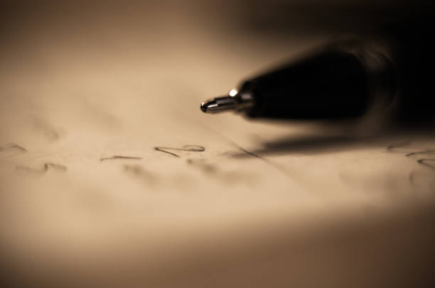 istock ball point pen and a sheet of paper 923104200