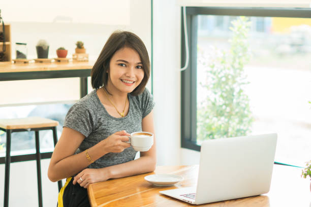 istock Freelance Businesswoman drinking coffee and using tablet computer in  coffee shop 923104522