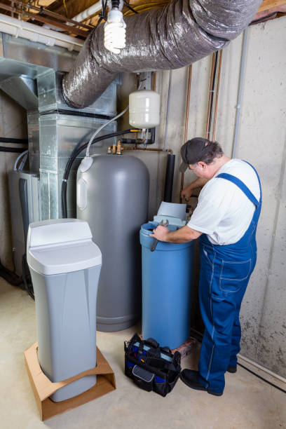 istock Experienced home installer fixing a water softener 923107014