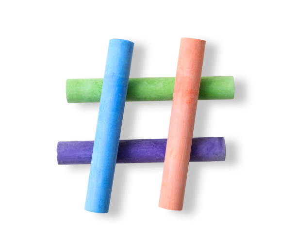 Hashtag sign made from crossed colorful chalks on white background