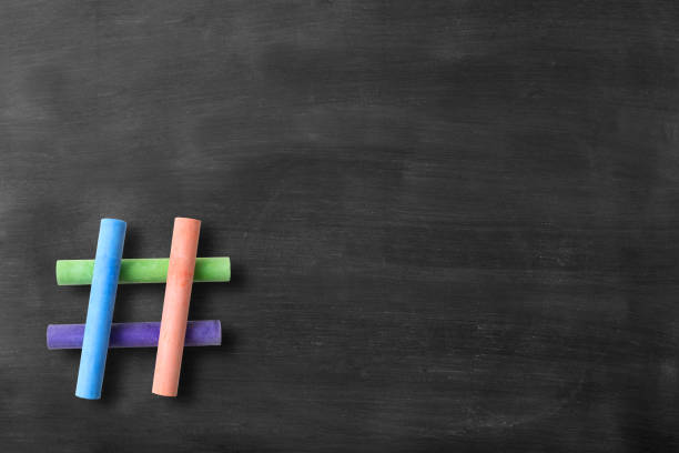 istock Hashtag sign made from crossed colorful chalks on blackboard 923113842