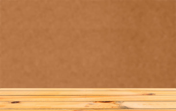 istock A wooden table with an orange background 923114046