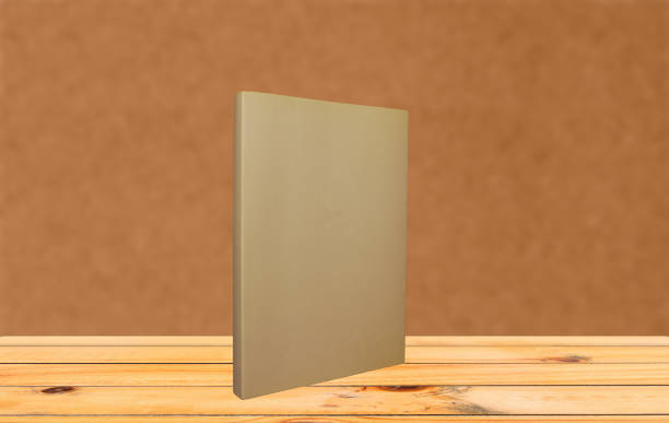 istock Book on a wooden table with orange background 923114058