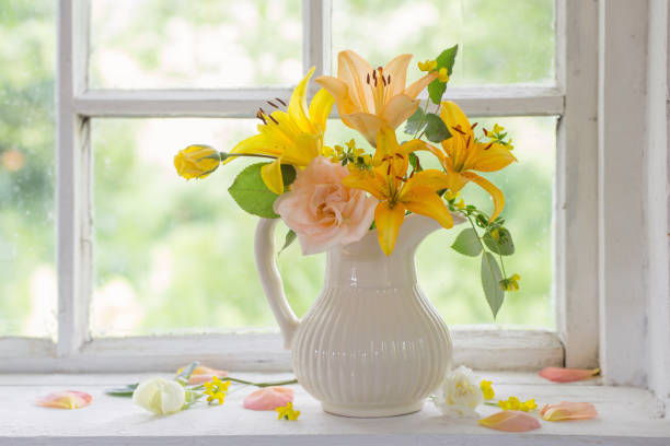 istock flowers in vase on windowsill 923114084