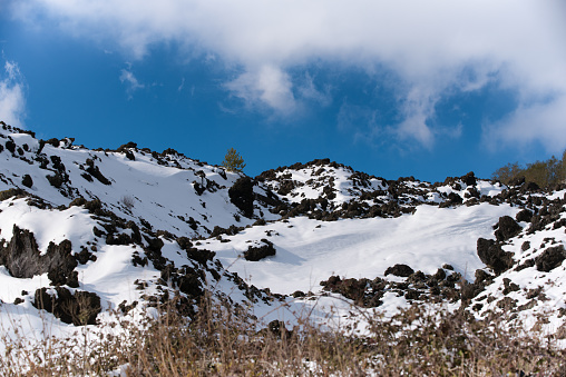 sciara with snow on the volcano Etna