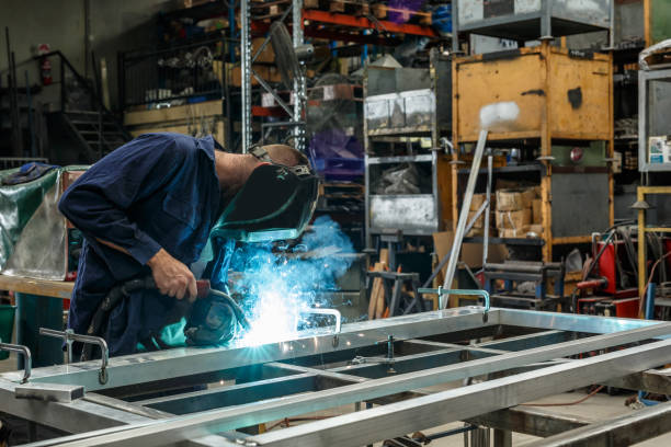 Metal Worker Welding In Factory