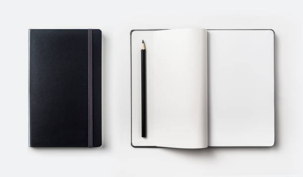 istock black hardcover notebook, white open & flip curl rolled page and black pencil isolated on background for mockup 923120086