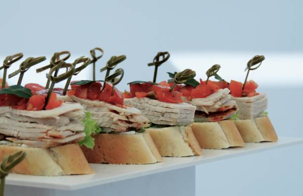 istock Variety starters with ham and greens on white plate close up 923121236