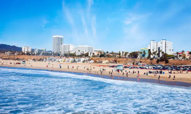 a view of Santa Monica beach with crowd at the beach enjoying a sunny day