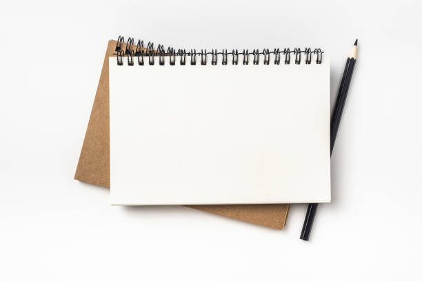 istock Top view of two kraft spiral notebook and black pencil 923126584