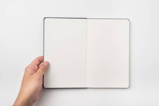 istock Top view of man's hand hold black hardcover notebook 923126774