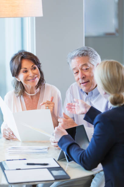 istock Senior couple talking with financial advisor 923126784