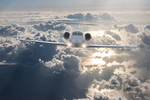 Private Jet Flying over clouds