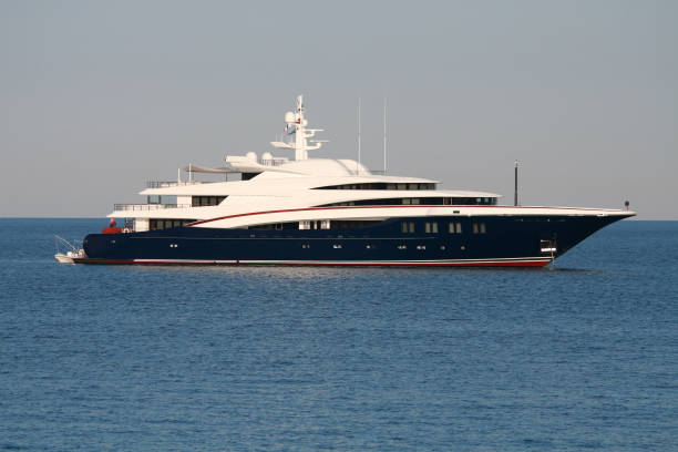 Large white super yacht with dark blue hull and red stripe, at anchor off Antibes in France. Please see my other yacht profile photos... 