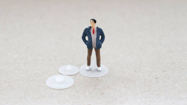 istock A miniature man standing in on springs. 923154956