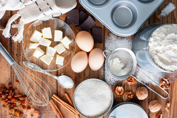 istock Ingredients for making cupcakes on a wooden table, top view 923162762