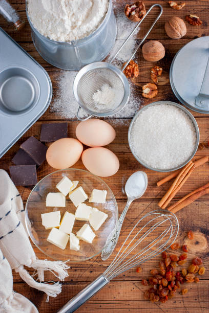 istock Ingredients for cooking cupcakes: butter, eggs, flour, sugar, nuts, raisins, form on a wooden table, top view, selective focus 923162786