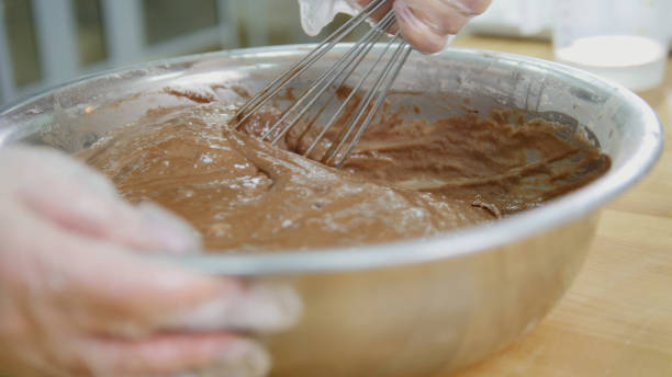 istock Baker mixes chocolate cream in metal bowl 923165770