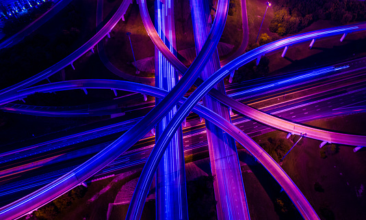 Straight down drone angle above transportation highways infrastructure and travel time in a ultraviolet finish