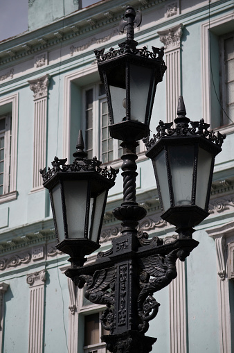 Elegant wrought iron street lamps were added in 1834 to the Paseo del Prado, the most popular and picturesque boulevard in Havana, Cuba.   The late 19th and pastel colored private houses have been carefully restored and brought back to life. \n\nPlease see more photos from this country in my Lightbox [url=http://www.istockphoto.com/search/lightbox/19934573?facets=%7B%22pageNumber%22:1,%22perPage%22:100,%22abstractType%22:%5B%22photos%22,%22illustrations%22,%22video%22,%22audio%22%5D,%22order%22:%22bestMatch%22,%22filterContent%22:%22false%22,%22lightboxID%22:%5B19934573%5D,%22additionalAudio%22:%22true%22,%22f%22:true%7D]Cuba[/url]\n\n[url=file_closeup.php?id=9431696][img]file_thumbview_approve.php?size=1&id=9431696[/img][/url]