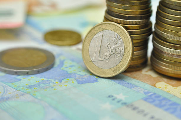 istock Euro coins over paper euro banknotes 923170056